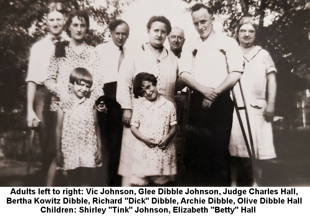 Black and white photo of Victor Johnson, Glee Dibble Johnson, Judge Charles P. Hall, Bertha Kowitz Dibble, Richard 'Dick' Dibble, Archie Dibble (with crutches), and Olive 